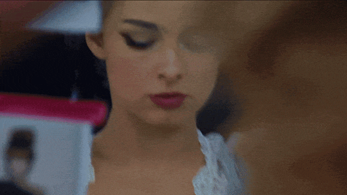 a close up of a woman 's face with a blurred background
