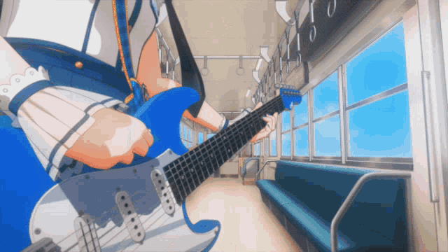 a person is playing a blue guitar in a train