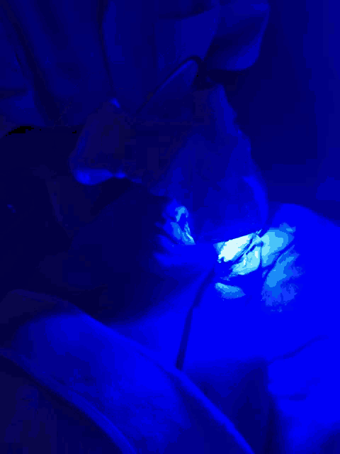 a person is getting a treatment with a blue light