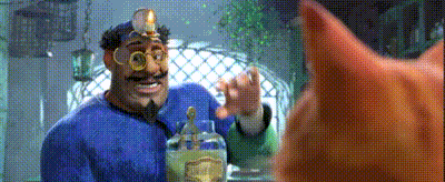 a man with a beard and goggles is holding a bottle and talking to a cat