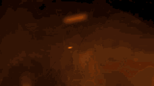 a dragon is flying through the air in front of a fire .