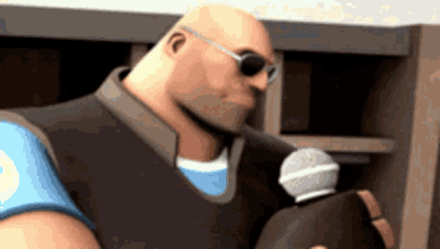 a bald man wearing sunglasses holds a microphone in his hand