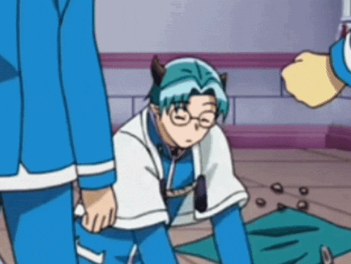 a man with blue hair and glasses is kneeling on the floor in a room .