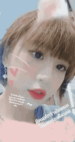 a close up of a woman 's face with chinese writing on the bottom right