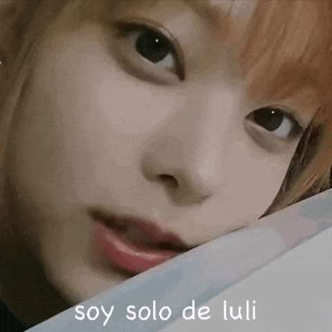a close up of a woman 's face with the words `` soy solo de luli '' written above her .