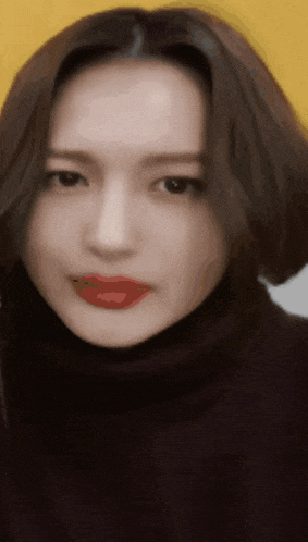 a close up of a woman wearing a black turtleneck and red lipstick