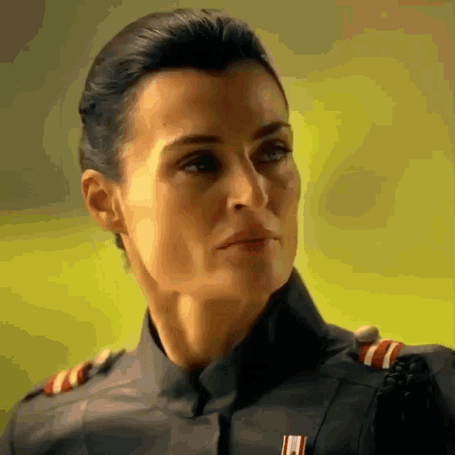 a close up of a woman 's face wearing a black uniform