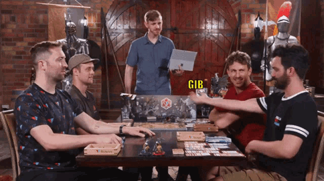 a group of men are playing a board game and one of them has the word gib on his shirt