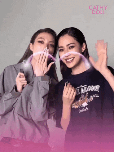 two women are posing for a picture and one is wearing a shirt that says " alone friends "