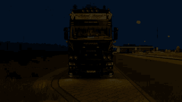 a black truck with the word scania on it