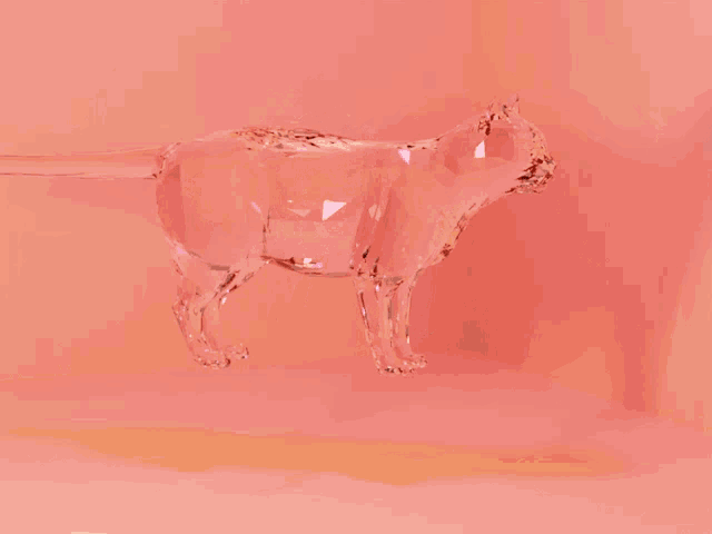 a statue of a cat made out of confetti on a pink background