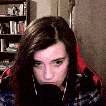 a woman in a plaid shirt sits in front of a bookshelf with a book titled ' a man ' on the top