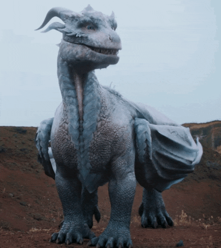 a white dragon with horns is standing in a desert