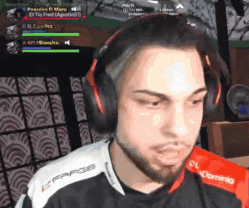 a man wearing headphones and a shirt that says frags