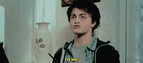 harry potter is wearing glasses and holding a pencil and says `` try me '' .