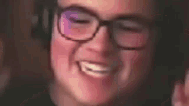 a close up of a person wearing glasses smiling .