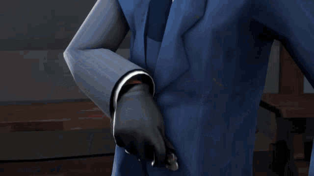 a man in a blue suit and tie is pointing at his pocket .