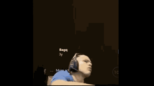 a man wearing headphones is making a face with his hands .