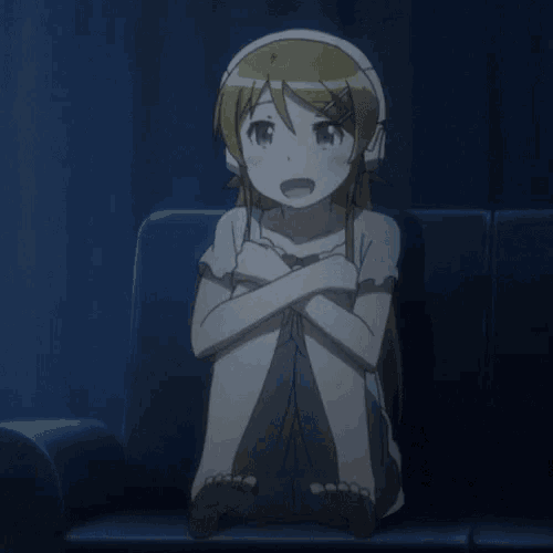a girl in headphones sits on a couch with her legs crossed
