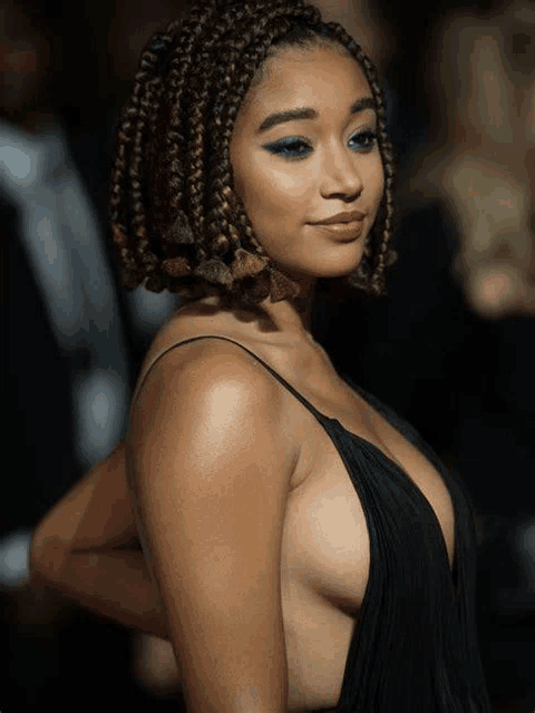 a woman with braids and a plunging neckline