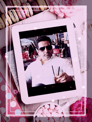 a picture of a man on a tablet surrounded by hearts