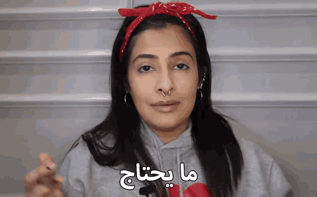 a woman with a nose ring and a bandana on her head says " what a waste "