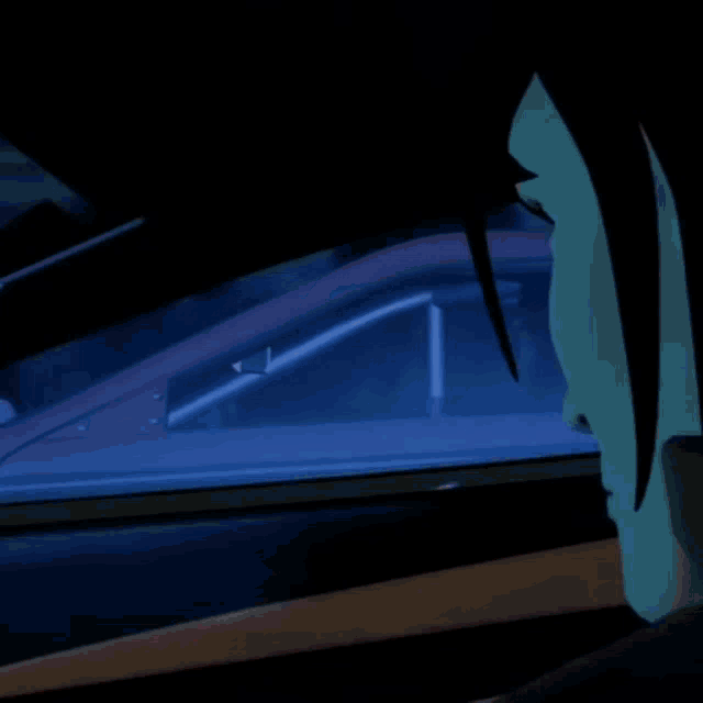 a cartoon character is looking out a car window at night