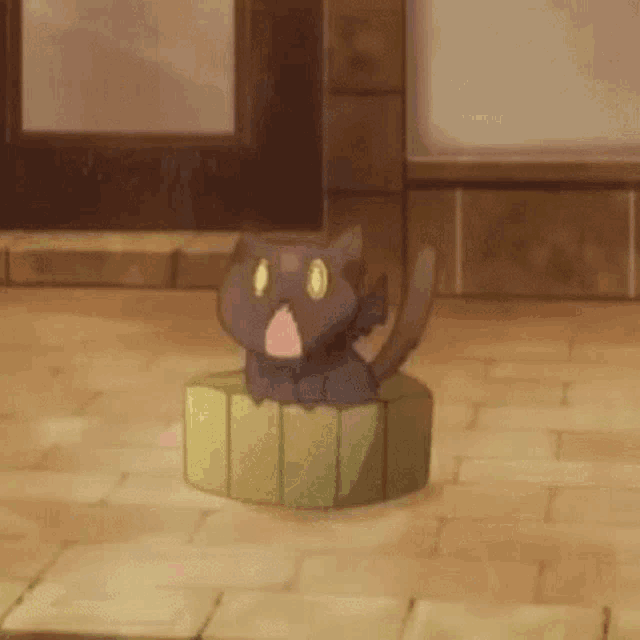 a cat is sitting on top of a green box on a tiled floor .