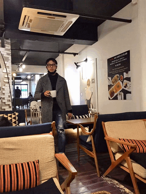 a man stands in a restaurant with a sign on the wall that says ' netflix ' on it