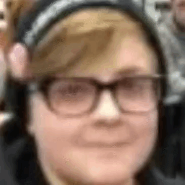 a close up of a person 's face with glasses and headphones .