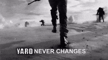 a black and white photo of a man walking in the snow with the words yard never changes written below him .