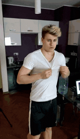 a man in a white shirt and black shorts is holding a water bottle