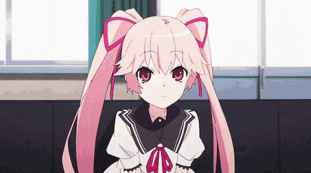 a girl with pink hair is sitting on a couch