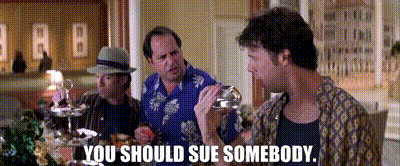 three men are sitting at a table and one of them is holding a glass and says you should sue somebody .