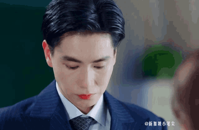 a man wearing a suit and tie with red lipstick on his lips