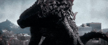 a monster is standing in front of a city skyline