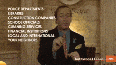 a man in a suit and tie is talking about police departments