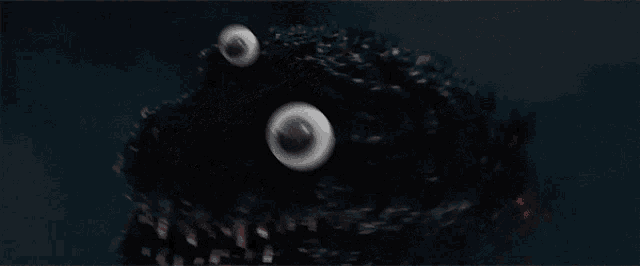 a close up of a monster 's face with big eyes