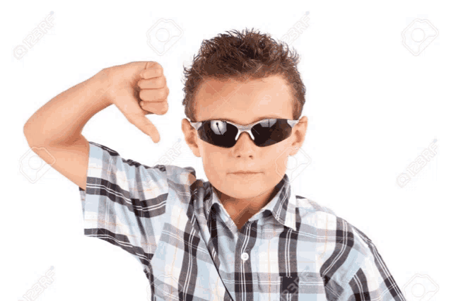 a young boy wearing sunglasses giving a thumbs down