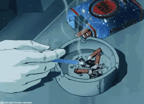 a person is lighting a cigarette in an ashtray with a pack of cigarettes in the background .