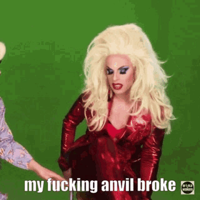 a drag queen in a red dress is holding someone 's hand and says my fucking anvil broke .