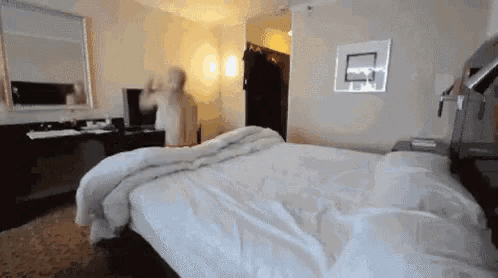 a hotel room with a basketball hoop on the wall above a bed