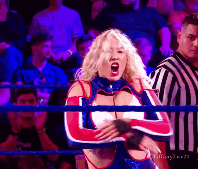 a woman in a red white and blue outfit stands in a boxing ring with tiffanyluv24 written on the bottom right