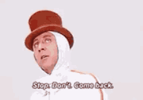 a man wearing a top hat and a white costume is talking .