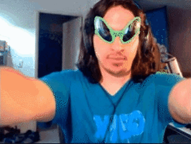 a man wearing sunglasses and a shirt that says ' yes ' on it