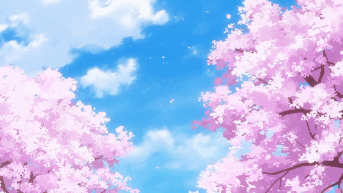 a tree with pink flowers against a blue sky with clouds