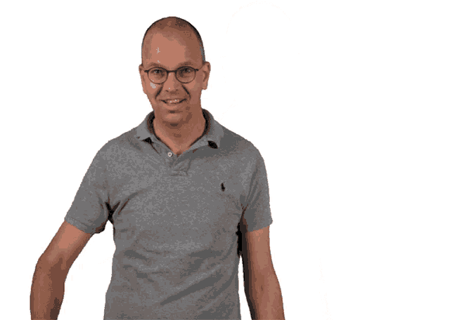 a man wearing glasses and a grey polo shirt giving a thumbs up