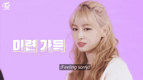 a girl with blonde hair says " feeling sorry " in front of a pink background