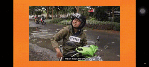 a man riding a green motorcycle with a tag that says n @ jek