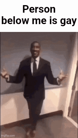 a man in a suit and tie is dancing in a hallway with the words `` person below me is gay '' .
